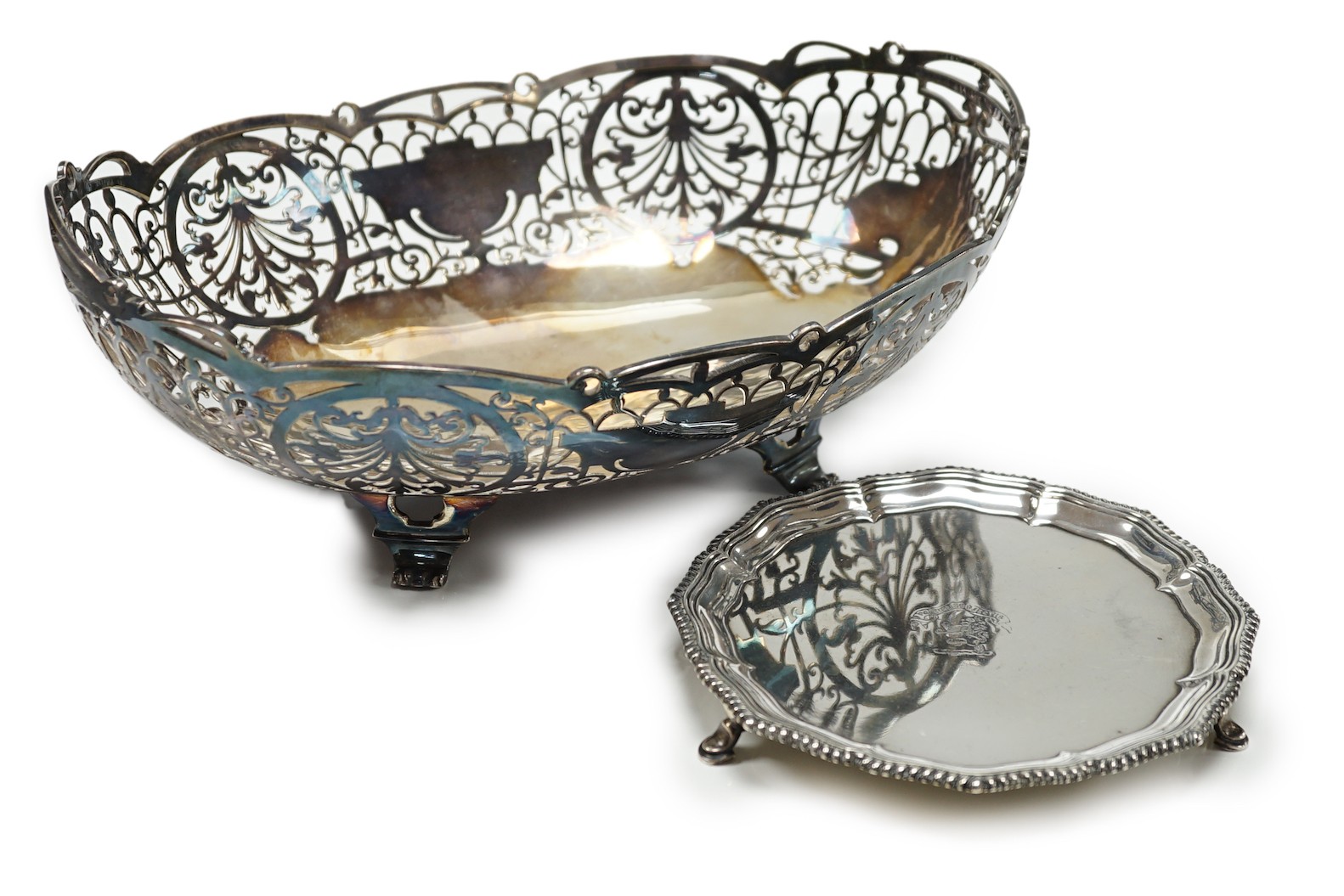 An Elizabeth II pierced silver oval fruit bowl, Poston Products Ltd, Sheffield, 1955, 28.6cm, together with a late Victorian silver waiter, London, 1898, 28.1oz.